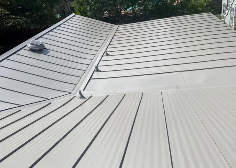 Solar attic fan installed on a metal roof for Roof Ventilation in Brownfields